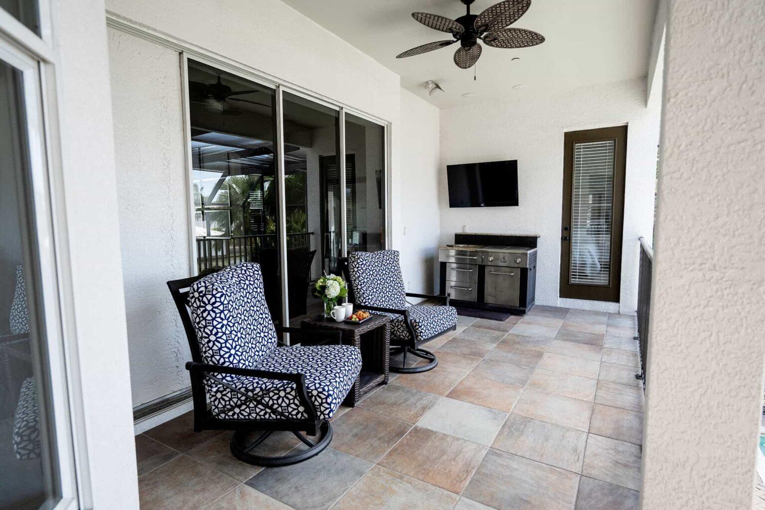 naples fl vacation home Main floor wraparound screened lanai - glass doors fully open, tv, and gas grill.