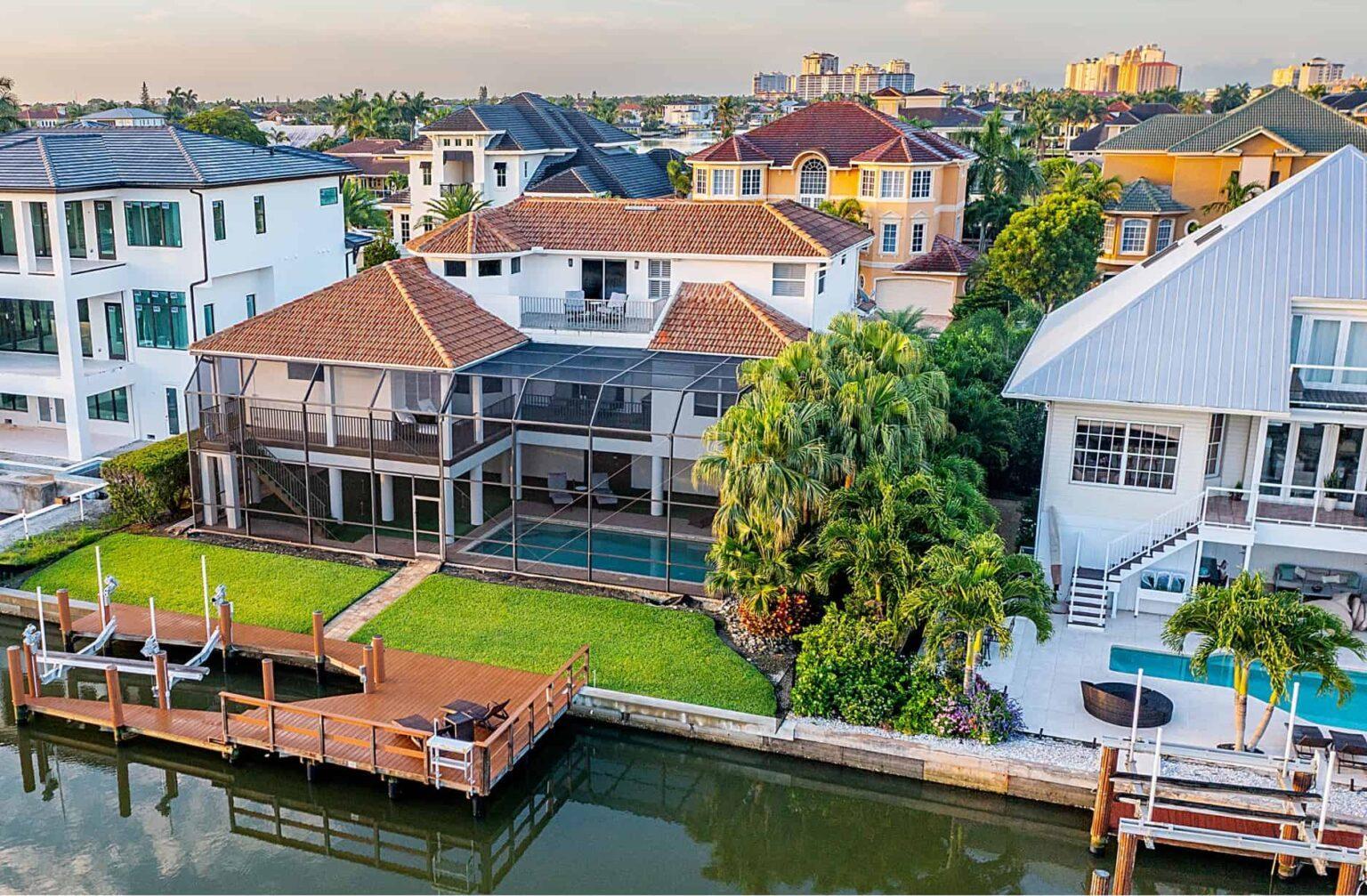naples, fl vacation home Backyard from aerial shot. on canal with boat dock and screened in pool